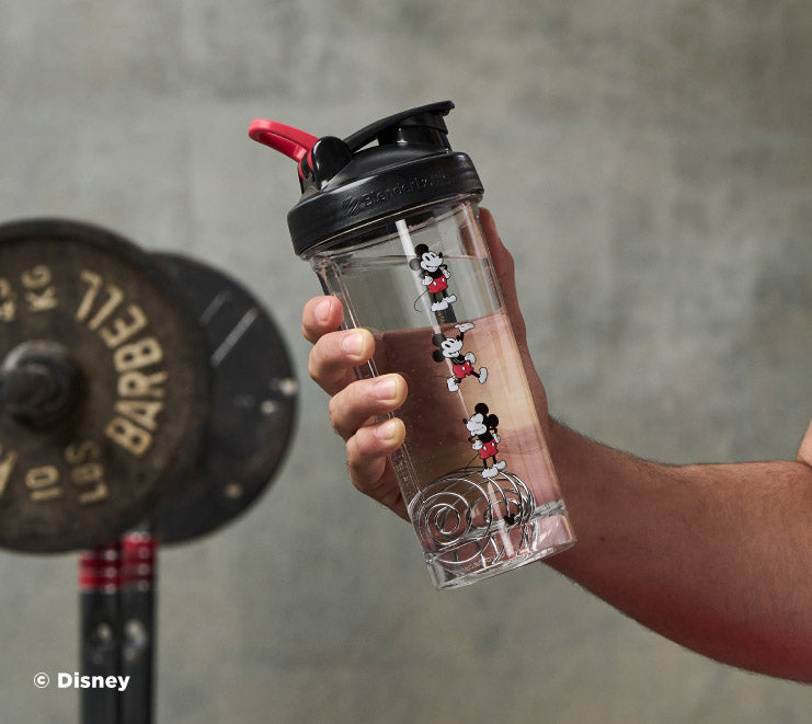 pro-series-p7 Mickey_Mouse_Protein_Shaker_Bottle_Being_Held_In_the_Gym.jpg